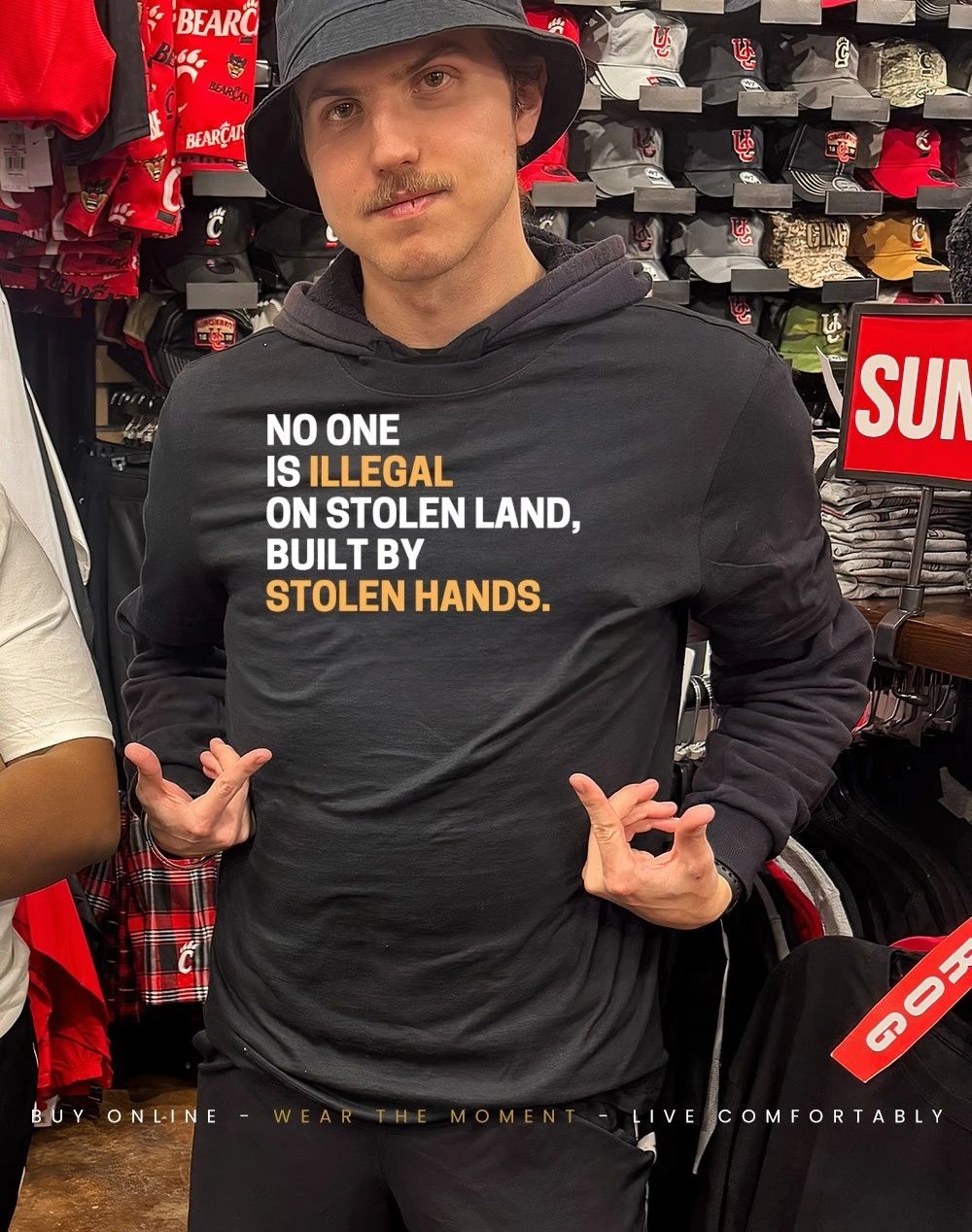Black woman wearing no one is Illegal on stolen land built by stolen hands shirt