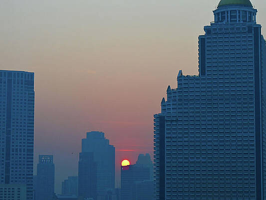 Sunset Over  Highrise Buildings In Bangkok Thailand Print
