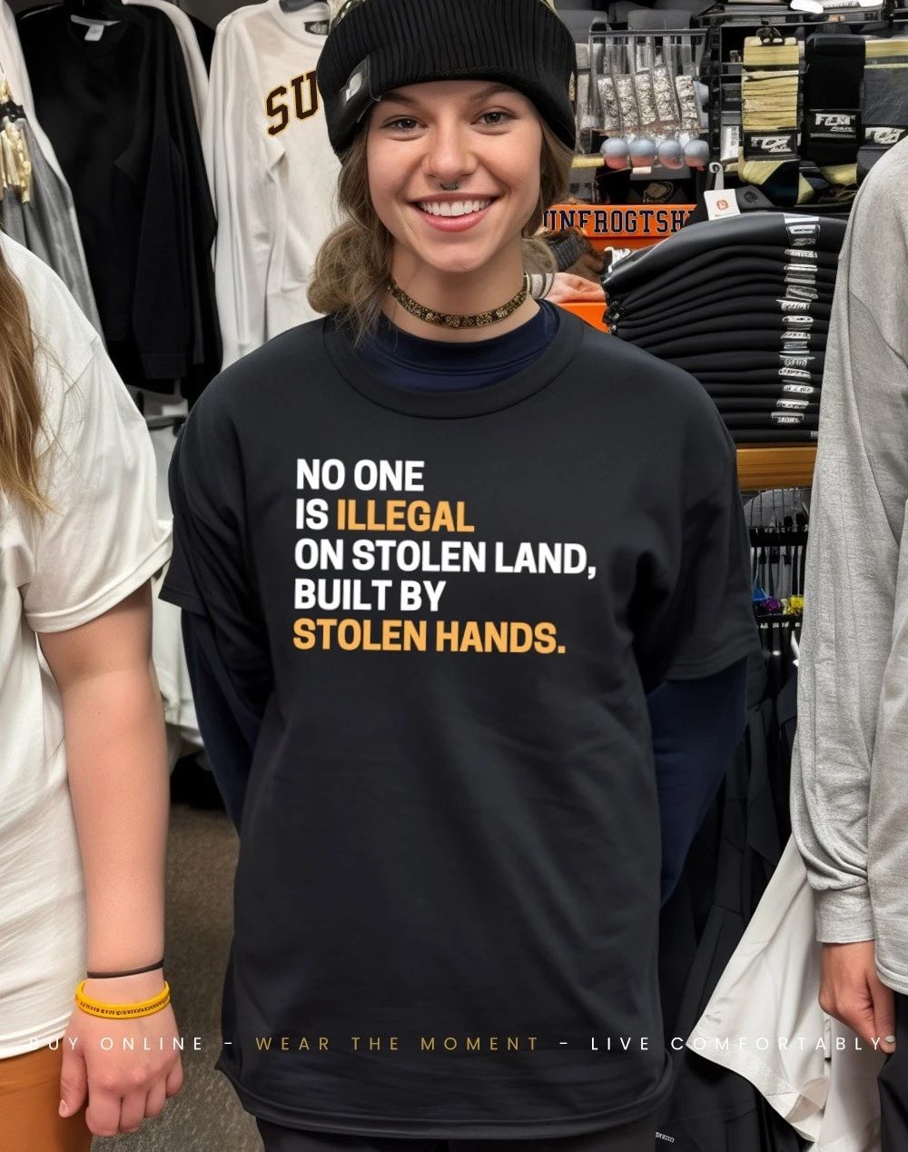 Black woman wearing no one is Illegal on stolen land built by stolen hands shirt