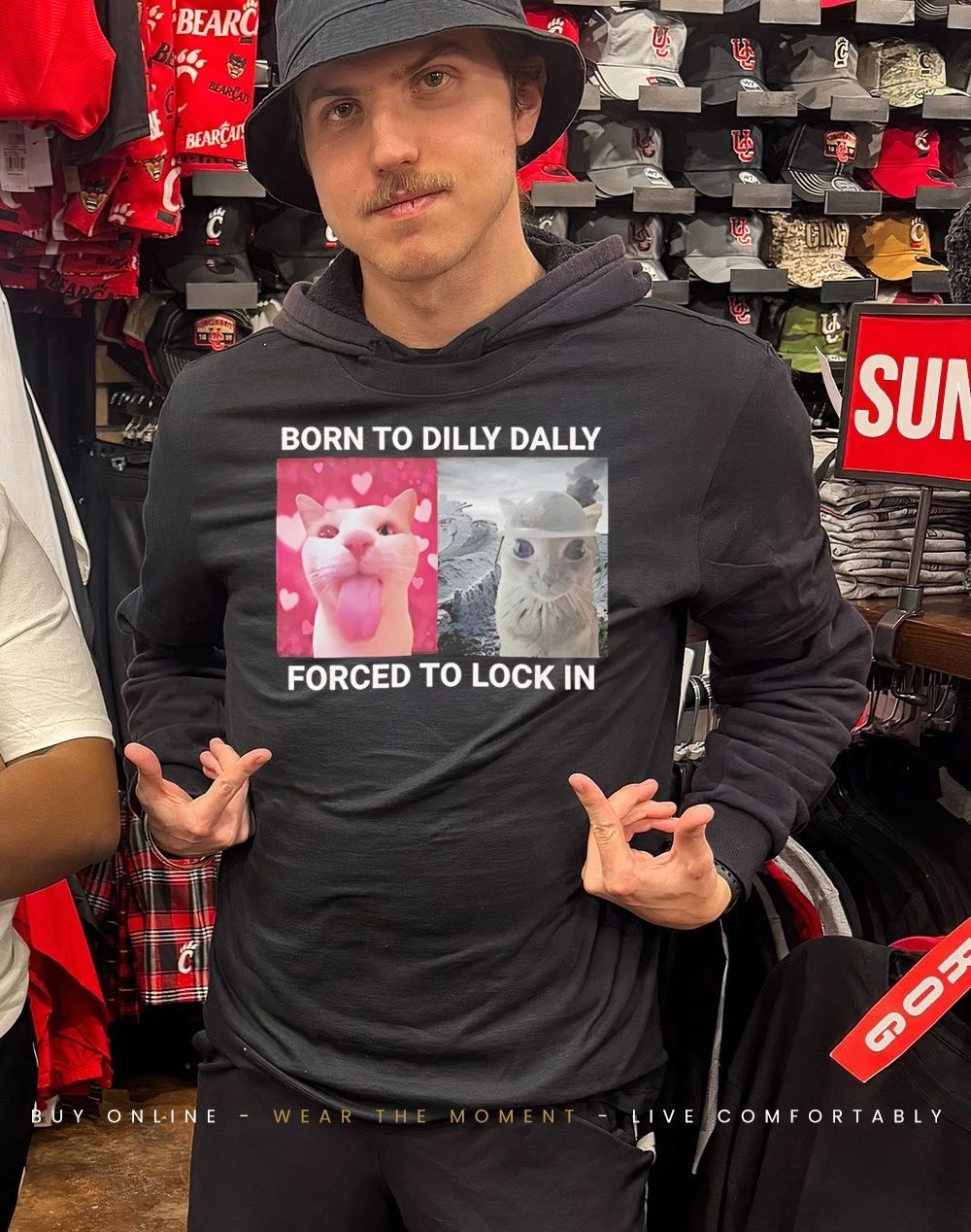 Cat born to dilly dally forced to lock in shirt